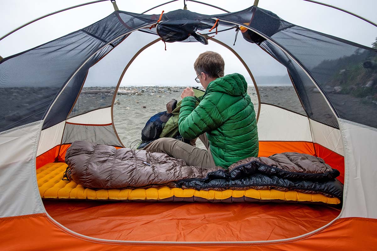 Sitting on backpacking quilt and sleeping pad in tent (Katabatic Gear Flex)